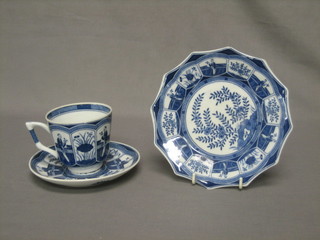 An Oriental blue and white cup and saucer the base with character mark together with a circular plate