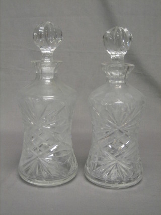 A pair of thistle shaped cut glass decanters and stoppers
