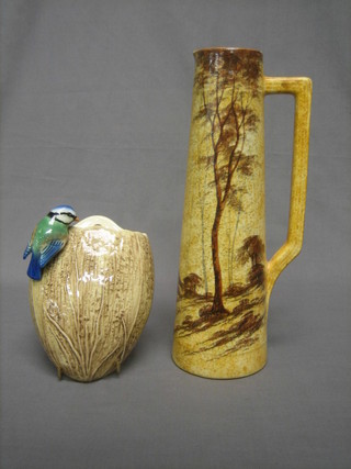 An Art Pottery tapering vase decorated trees 14" together with a Sylvac wall pocket decorated a bird 7"