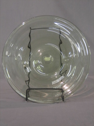 A circular smoked glass charger 14"