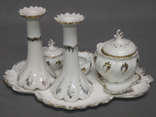 A 7 piece dressing table set comprising scallop shaped tray, pair of candlesticks, pair of circular jars and covers (1 lid missing), pin tray, circular jar and cover