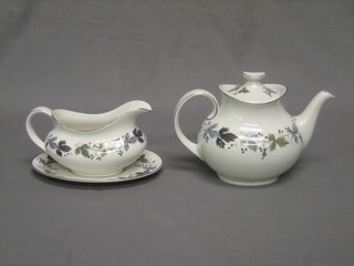 A 10 piece Royal Doulton Burgundy Pattern tea service comprising teapot, coffee pot, 2 large jugs, sauce boat and stand, 2 circular dishes 5", 2 sugar bowls 4 1/2" and 3 1/2" and a cream jug
