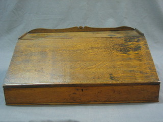 An 18th Century oak clerk's slope with three-quarter gallery and hinged lid 17"