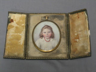 A portrait miniature of a young girl, contained in a gilt frame 3 1/2" oval