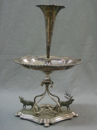 A silver plated table centre piece with epergne to the centre above a bowl, the base supported by 2 stags (1f) 18"