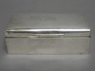 A rectangular silver cigarette box with solid lid, London 1913 7"