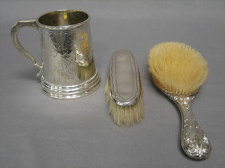 A Victorian engraved silver plated tankard and a silver backed hairbrush and clothes brush