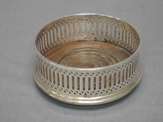 A modern circular pierced silver bottle coaster 3 1/2"