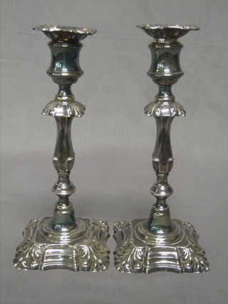 A pair of Rococo style silver plated candlesticks by Elkingtons with detachable sconces 10"