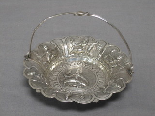 An Eastern embossed silver bowl decorated a Deity, with swing handle 1 ozs