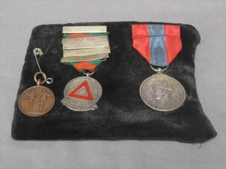 A George VI Imperial Service Medal to Evan Evens together with a Safe Driving Campaign medal and a bronze sporting medal