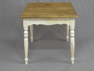 A 19th Century French elm kitchen table with white painted base, raised on turned supports