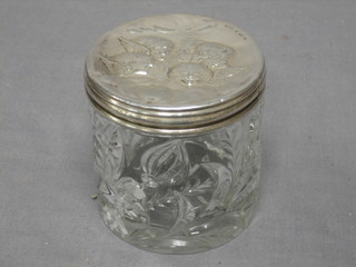 An Edwardian cylindrical dressing table jar with embossed silver lid, Birmingham 1912