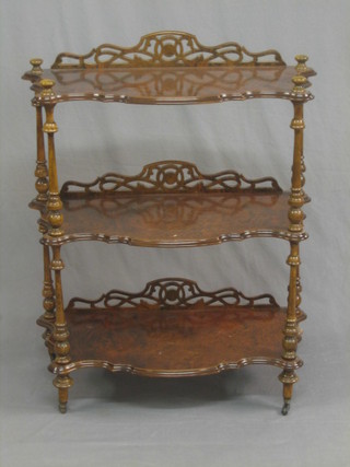 A 3 tier walnut what-not of serpentine outline, raised on turned supports 31"