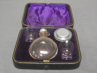 A 19th Century travelling communion set comprising pressed metal wafer box, 2 glass beakers and jug, cased