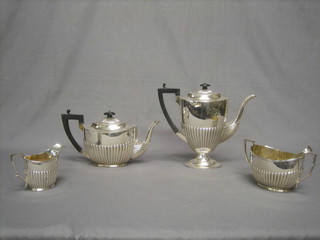 A Georgian style silver plated 4 piece tea/coffee service of oval form with demi-reeded decoration comprising teapot, coffee pot, twin handled sugar bowl and cream jug and a pair of George III silver sugar tongs