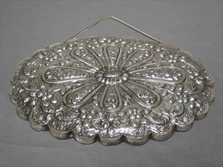 An oval mirror contained in a Continental embossed silver frame marked Cemai 900, 9 1/2"