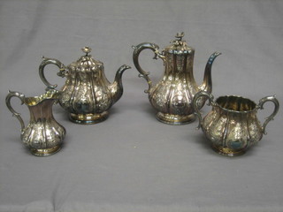 A handsome Victorian engraved silver plated 4 piece tea/coffee service comprising teapot, coffee pot, twin handled sugar bowl and cream jug, of embossed melon form together with 3 pairs of silver plated sugar tongs