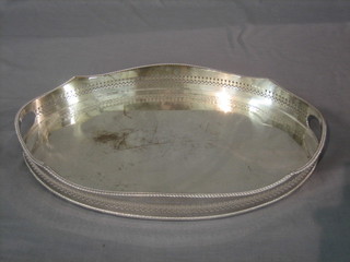 An oval twin handled silver plated tea tray, raised on bun feet