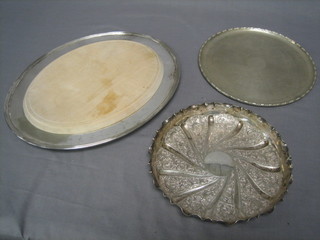 A circular embossed silver plated dish 8", do. salver 9" and an oval silver plated bread board 13"