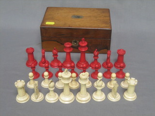 A Victorian white and red ivory chess set contained in a rosewood box with hinged lid