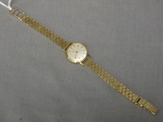 A lady's Tissot gold cased wristwatch with an integral gold bracelet