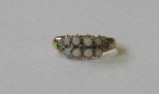 A Victorian 18ct gold dress ring set 8 opals and other stones (1 missing)