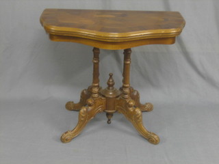 A Victorian style figured walnut shaped card table, raised on turned supports 33"