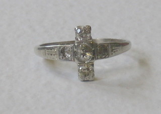 A lady's platinum cross shaped dress ring set 5 diamonds