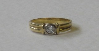 An 18ct gold dress/engagement ring set a diamond