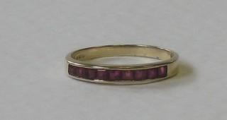 A 9ct gold half eternity ring set rubies