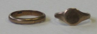 A 9ct gold wedding band and a 15ct gold signet ring