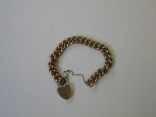 A 9ct hollow gold curb link bracelet with heart shaped padlock