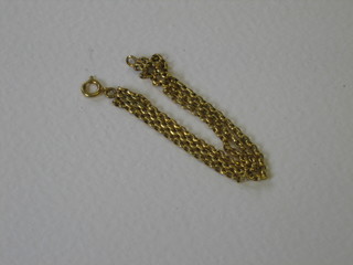 A gold multi link curb bracelet