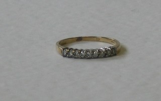 A gold half eternity ring set diamonds