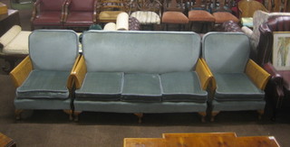 A 3 piece bleached walnut single cane Bergere suite  comprising 2 seat settee and 2 matching armchairs upholstered in blue material, raised on cabriole supports