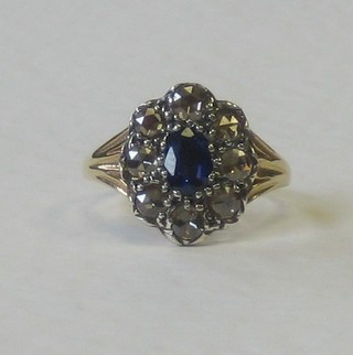 An antique style 18ct yellow gold dress ring set an oval cut sapphire supported by diamonds