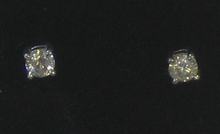 A pair of circular diamond stud earrings approx 0.50ct
