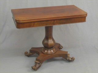 A Victorian mahogany D shaped tea table raised on turned column with triform base 36"