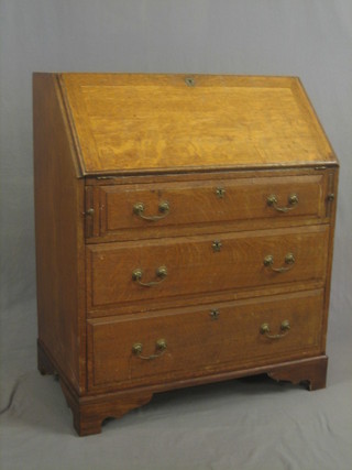 A Georgian honey oak bureau, the fall front revealing a well fitted interior above 3 long graduated drawers, raised on bracket feet 33"
