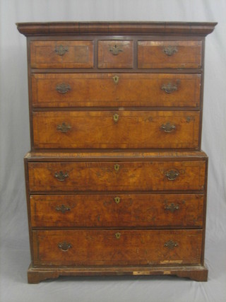 A Queen Anne walnut chest on chest, the upper section with moulded cornice fitted 3 long drawers above 2 short drawers (possibly reduced in height), the base fitted 3 long drawers, raised on bracket feet 45"