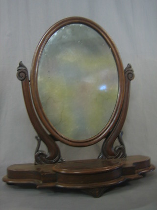 A Victorian oval plate dressing table mirror contained in a mahogany swing frame, the base of serpentine outline fitted a trinket box, raised on bracket feet 26"