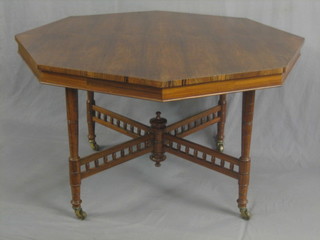 A Victorian octagonal rosewood centre table raised on turned supports with X framed stretcher 48"