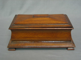 A mahogany sarcophagus shaped trinket box with hinged lid, raised on ogee bracket feet 11 1/2"