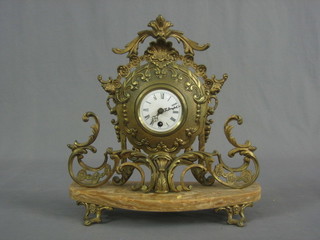 A French 19th Century mantel clock with silvered dial and Roman numerals contained in a gilt metal and marble case