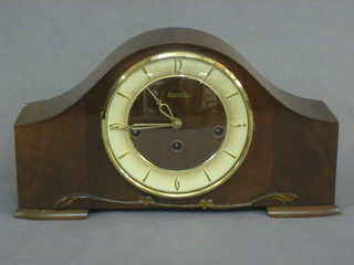 A 1940's chiming mantel clock with Roman numerals contained in a walnut arch shaped case by Hermle