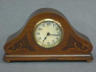 A French mantel clock with 3" paper dial and Arabic numerals contained in an inlaid mahogany arch shaped case