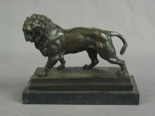A modern bronze figure of a walking lion raised on  a marble base 10"