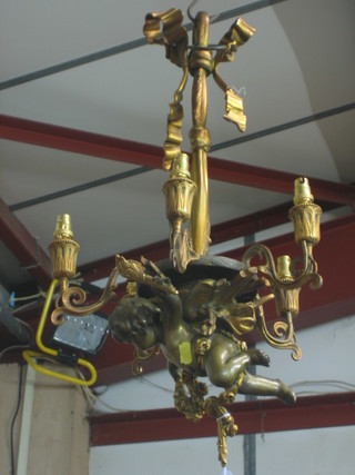 A bronze and gilt metal 5 light electrolier, the centre decorated a figure of a cherub