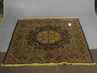 A contemporary Persian blue ground rug with central rose medallions 58" x 57"